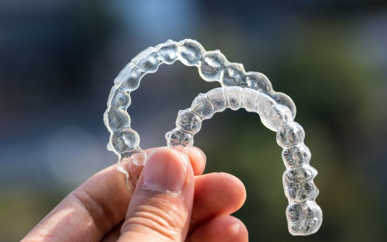 someone holding two retainers